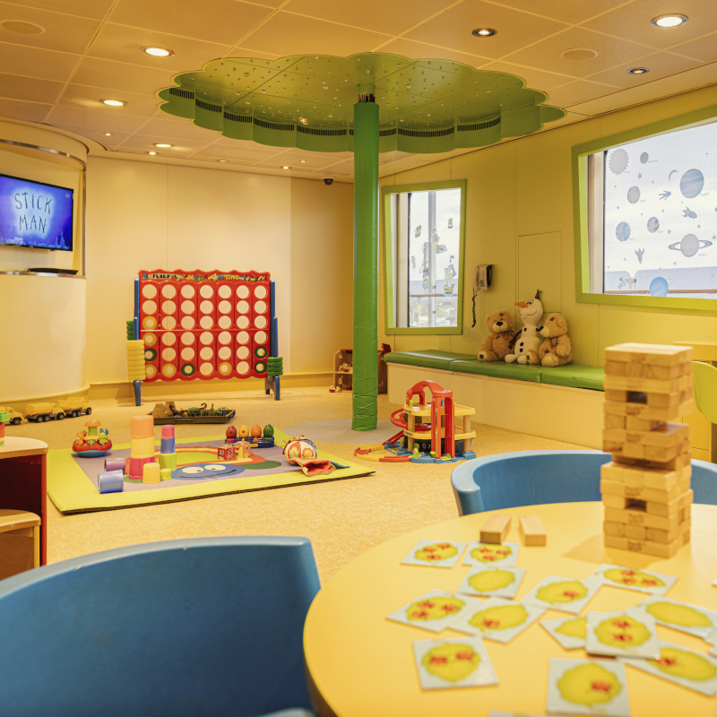 Colourful children's playroom on a ship with toys and a giant Connect Four.