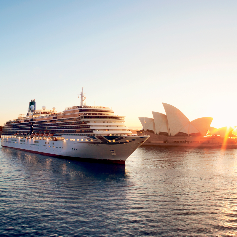 The P&O Arcadia cruise ship sailing past the Sydney Opera House during sunrise.