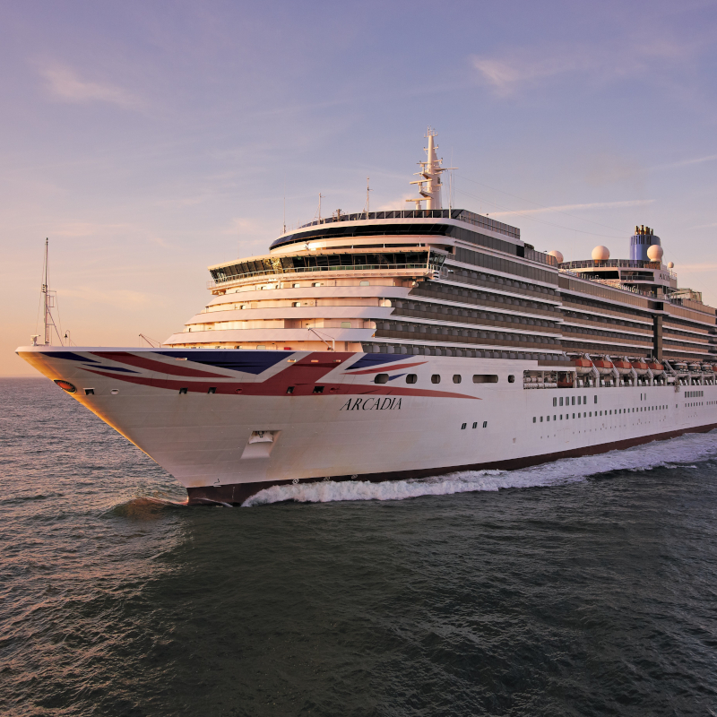 The P&O cruise ship Arcadia sailing on open blue waters at sunset.