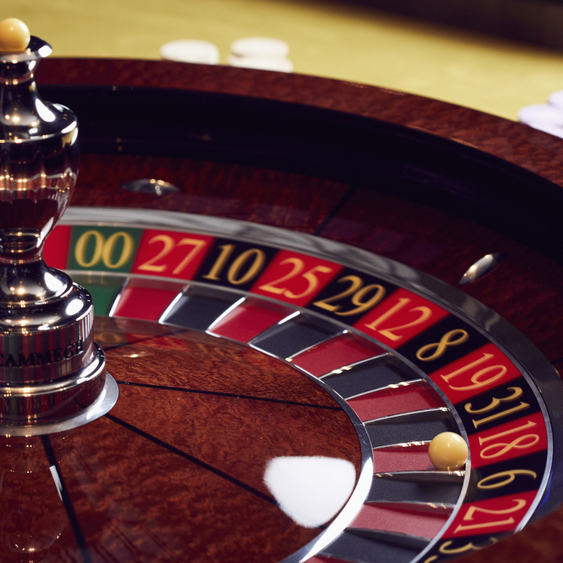 Close-up of a roulette wheel with a ball landing on a winning number inside a cruise ship casino.